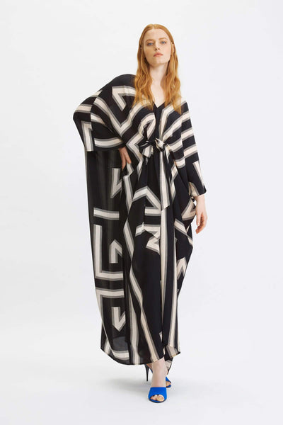 Women wearing a black and cream geometric patterned kaftan with a cinched waist
