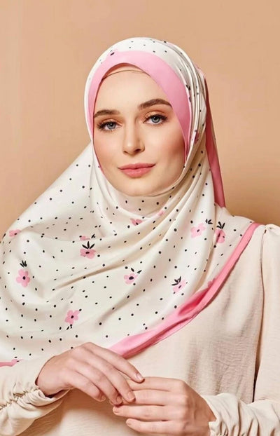 Elegant woman wearing a soft fabric Scarf adorned with blush pink flowers and black dots, ideal for fashion forward modest wear.