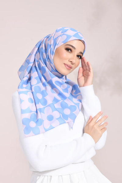 Stylish light blue floral hijab Blue Blossom Elegance Hijab, featuring white flower patterns on breathable fabric, perfect for versatile fashion statements