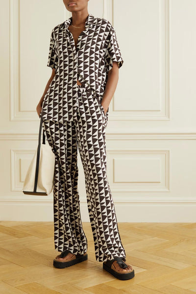 Women's geometric pattern co ord set featuring a black and white triangular design on a shirt and trousers ensemble, ideal for fashion forward attire