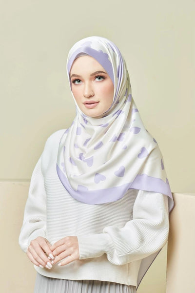 woman wearing a Lavender Love Hijab with a heart pattern, offering a blend of style and modesty, ideal for top fashion and Islamic wear