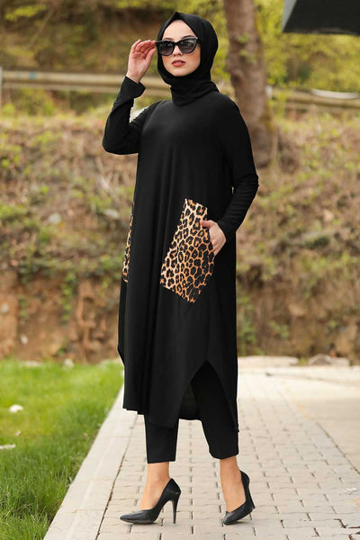 A woman in a stylish black tunic with leopard print pockets