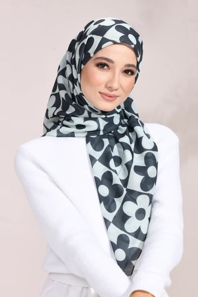 Elegant woman wearing a Monochrome Blossom Hijab with a black and white floral pattern, ideal for a sophisticated and stylish look