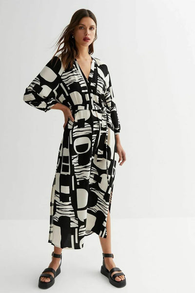 Model wearing Monochrome Mosaic Abstract Midi Shirt Dress with black and white geometric pattern, mid-length, and waist tie