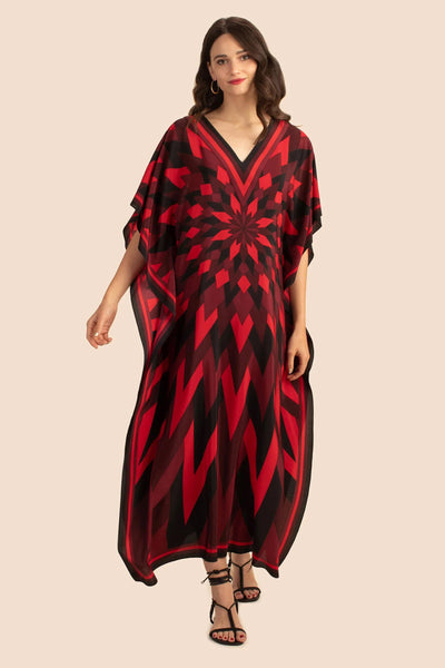 A striking kaftan with a dynamic red and black geometric pattern that radiates from the center, creating a mesmerizing optical illusion. The kaftan has a flowing, relaxed fit, with a V neckline and sheer fabric. 
