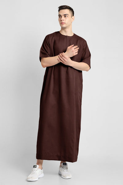 Man wearing a brown, ankle-length thobe with a relaxed fit, embodying a fusion of traditional charm and modern simplicity