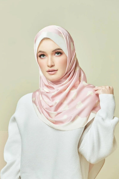 woman wearing a Pink Blush Hijab with a soft heart pattern, ideal for fashionable modest wear