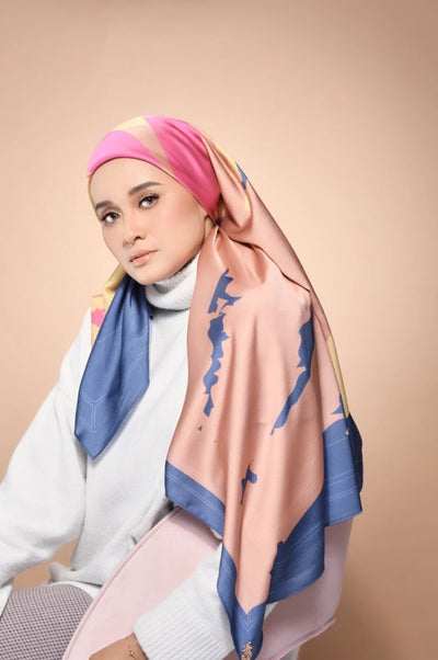 A model wearing a Scarf, featuring soft gradients of pink, blue, and yellow, akin to a peaceful evening sky, draped elegantly over her shoulders