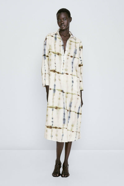 midi-length shirt dress with an abstract tie-dye pattern in white, beige, and navy blue hues