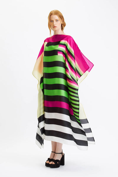 A vibrant striped silk kaftan with bold color block patterns in pink, green, black, and white.